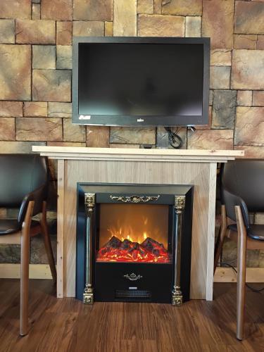 a fireplace with a television on top of it at Shiyai Taoyuan in Renai