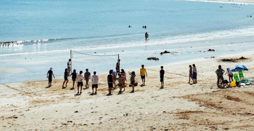 a group of people playing soccer on the beach at Villa Yumigahama in Minamiizu