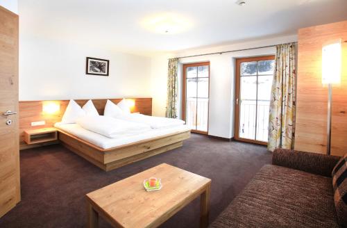 a hotel room with a bed and a table at Tarlack Appartements Hütten 34 in Leogang