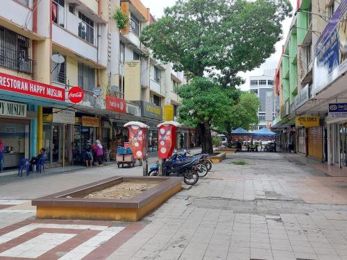 a city street with a fountain in the middle at Basung Homestay Sinsuran in Kota Kinabalu