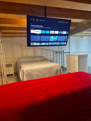 a bedroom with two beds and a large screen at Poseidone in Lipari