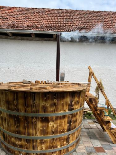 a wooden barrel with smoke coming out of it at Casa Ariana in Poiana Aiudului