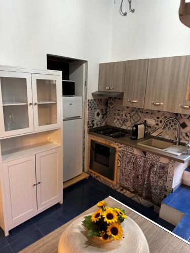 a kitchen with a table with sunflowers on it at Poseidone in Lipari