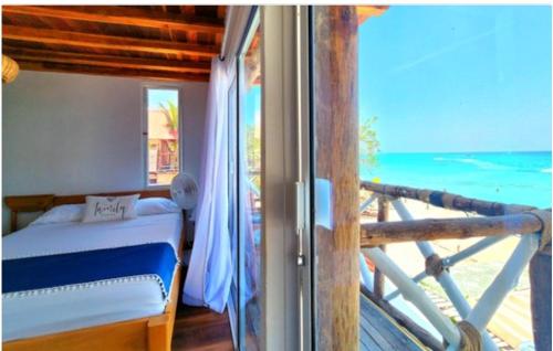 a bedroom with a bed and a view of the ocean at Cristal Blue Barú in Baru