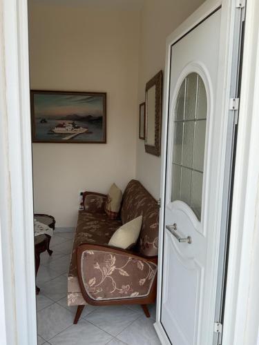 a living room with a couch and a chair at Aliki's Apartments in Skala Kallonis