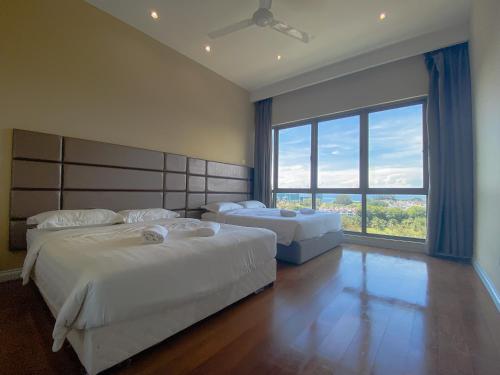 a bedroom with two beds and a large window at Maison life 小居屋 The Loft Imago in Kota Kinabalu