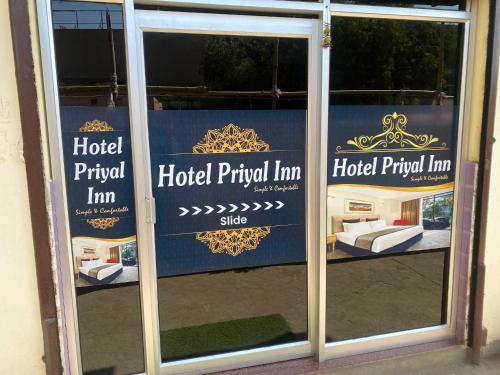 a sign in the window of a hotel principal inn at Hotel Priyal Inn in Bokāro