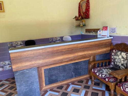 a bar with a bench and a chair in a room at Hotel Priyal Inn in Bokāro