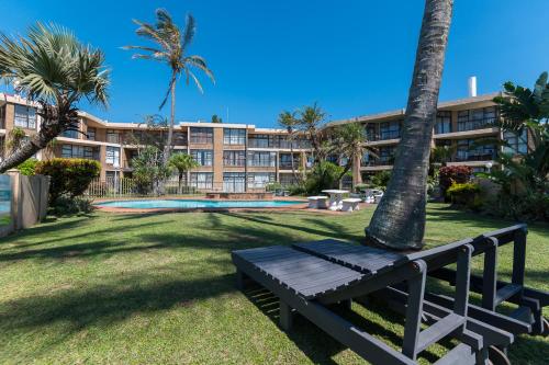 a park with a bench in front of a building at Boulder Bay 9 in Ballito