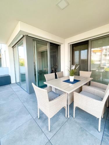 a patio with a table and chairs on a porch at MyFlat Viewpoint 57 in Siófok