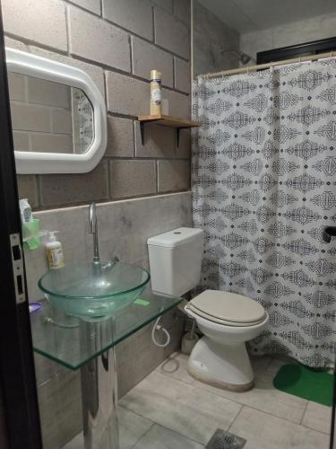 a bathroom with a toilet and a glass sink at Finca Morita in La Banda