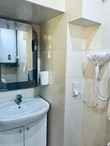 a bathroom with a sink and a mirror at Kharkovlux in Kharkiv