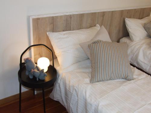 a bed with a night stand with a candle on it at Marconi 33A in Pergine Valsugana