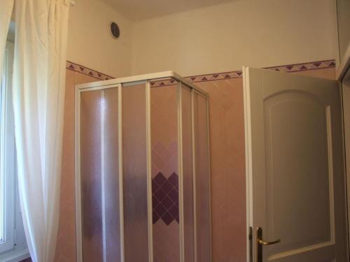 a shower stall in a bathroom with a curtain at Marconi 33A in Pergine Valsugana