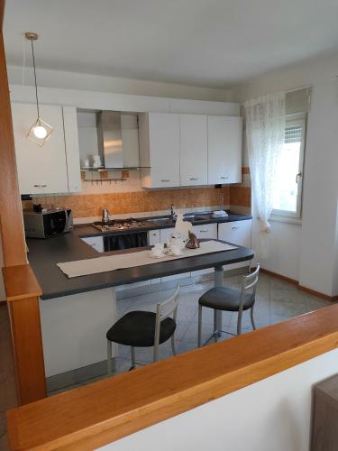 a kitchen with two chairs and a counter top at Marconi 33A in Pergine Valsugana