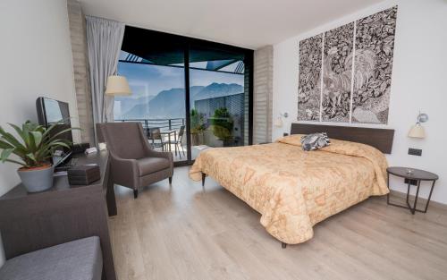 a bedroom with a bed and a chair and a balcony at B&B Vista Lago in Como