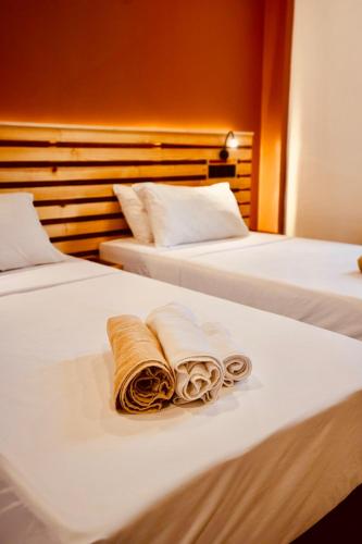 two beds with towels and pillows on them at Captal Island Villa in Mathiveri