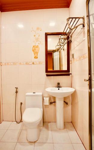 a bathroom with a toilet and a sink at Captal Island Villa in Mathiveri