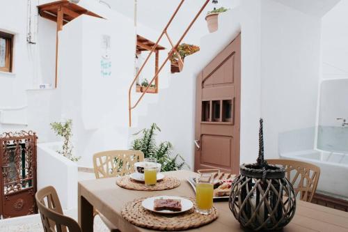 a table with two plates of food on it in a room at Castlevania- Traditional house in the Castle in Naxos Chora