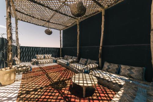a room with couches and a table in a tent at The Kozyhome in Ouarzazate