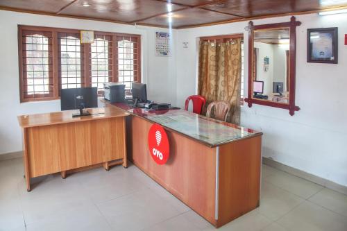 an office with a desk with a computer on it at Flagship Key 2 Heaven in Ooty