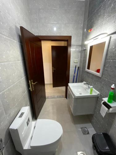 a bathroom with a toilet and a sink at Black IRIS in Jerash