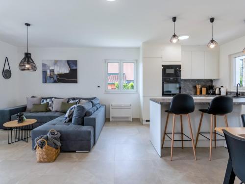 a living room and kitchen with a blue couch at Villa Tea by Rent Istria in Umag