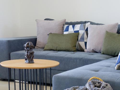 a living room with a blue couch and a table at Villa Tea by Rent Istria in Umag