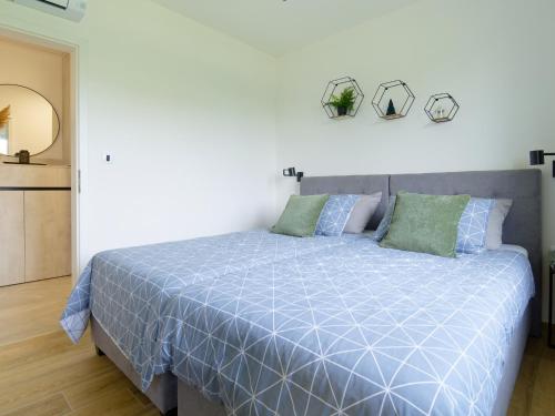 a bedroom with a bed with a blue comforter at Villa Tea by Rent Istria in Umag
