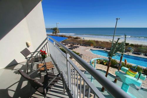 a balcony with a view of the beach and the ocean at Oceans One Resort in Myrtle Beach
