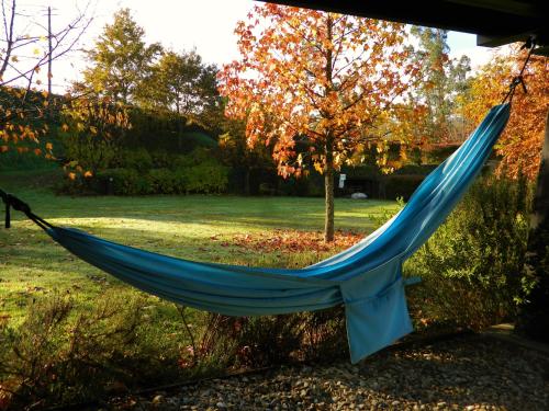 a blue hammock hanging in a yard at Treehouse Quinta Lamosa in Arcos de Valdevez