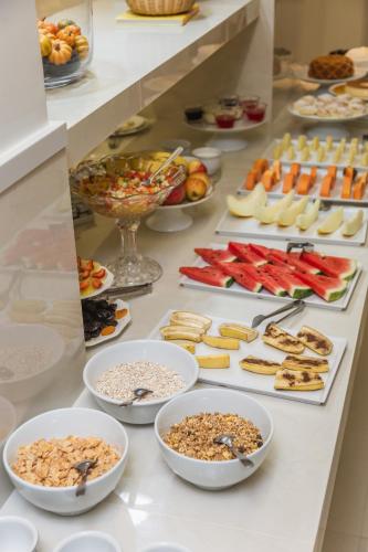 a buffet with many different types of food on a table at JR Hotel Marilia in Marília