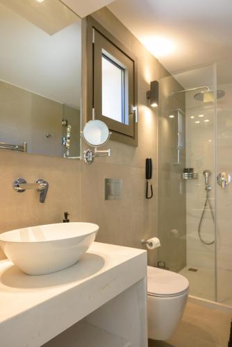 a bathroom with a sink and a toilet and a shower at Mirabella Hills in Agios Nikolaos