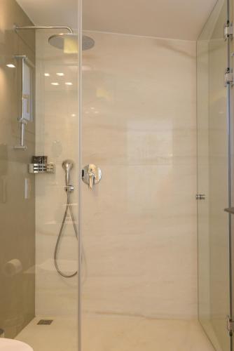 a shower with a glass door in a bathroom at Mirabella Hills in Agios Nikolaos