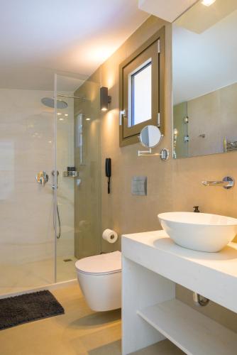 a bathroom with a sink and a toilet and a shower at Mirabella Hills in Agios Nikolaos