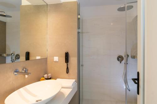 a bathroom with a sink and a shower at Mirabella Hills in Agios Nikolaos