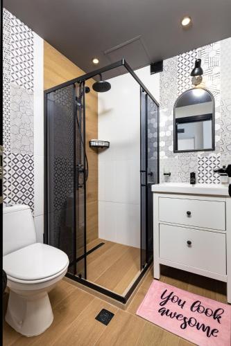 a bathroom with a shower and a toilet and a sink at Kapana Guest House on Central Pedestrian street with Parking included in Plovdiv