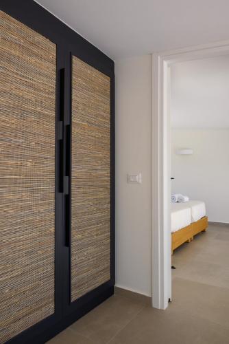 a bedroom with sliding doors with a bed in the background at Mirabella Hills in Agios Nikolaos