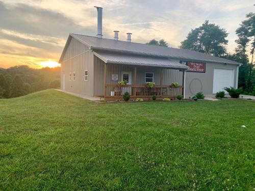 a small house with a large grassy yard at Holiday Inn Express & Suites New Martinsville by IHG in New Martinsville