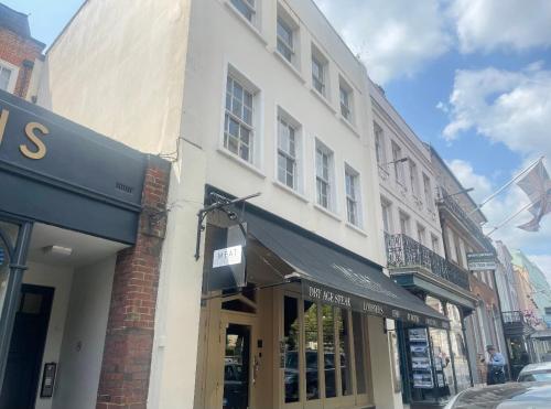 a store front of a building on a city street at WATCH CHANGING OF THE GUARD AND WALK TO THE CASTLE! 2 Bedroom Apartment in Windsor