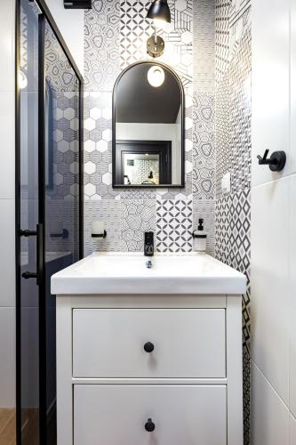 a bathroom with a white sink and a mirror at Kapana Guest House on Central Pedestrian street with Parking included in Plovdiv