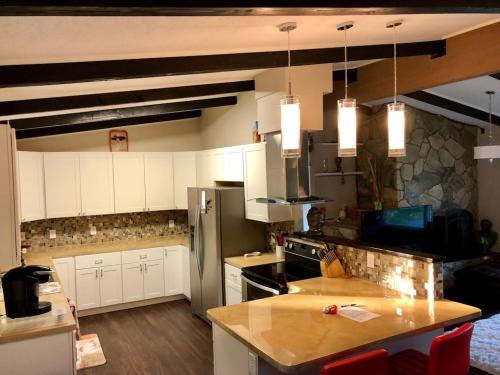 a kitchen with white cabinets and a counter top at Hot Tub Stunning Mountain Views 2 kitchens 4 bedroom 2 bathroom in Anchorage