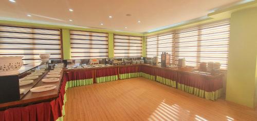 a large room with tables and counters and windows at Bulvar Hotel in Izmir