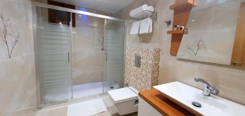 a bathroom with a shower and a sink and a toilet at Bulvar Hotel in Izmir