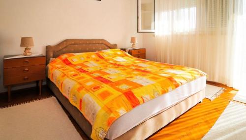 a bedroom with a bed and a dresser and a window at Apartmani Andjelka in Tivat