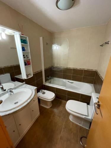 een badkamer met een wastafel, een toilet en een bad bij CASABLANCA in Arenas de San Pedro