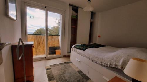 a bedroom with a bed and a large window at Vivienda Minca in La Herradura, Andalusien in La Herradura