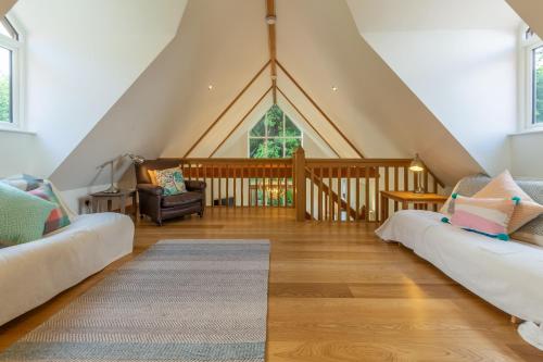 a attic living room with a gambrel roof at Woodland Pytchley in West Runton