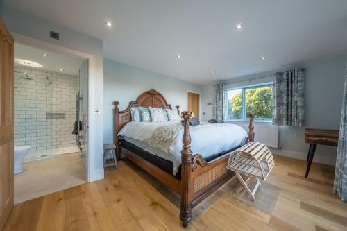 a bedroom with a large bed and a bathroom at Anchorage S in Salthouse