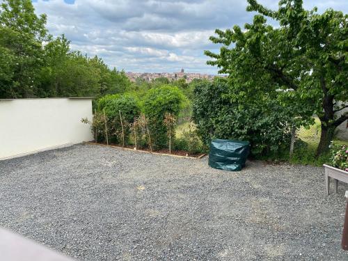 a parking lot with a trash can and a fence at "Luci" proche du Zenith, Arténium Ceyrat, Auvergne, parking privé , in Beaumont